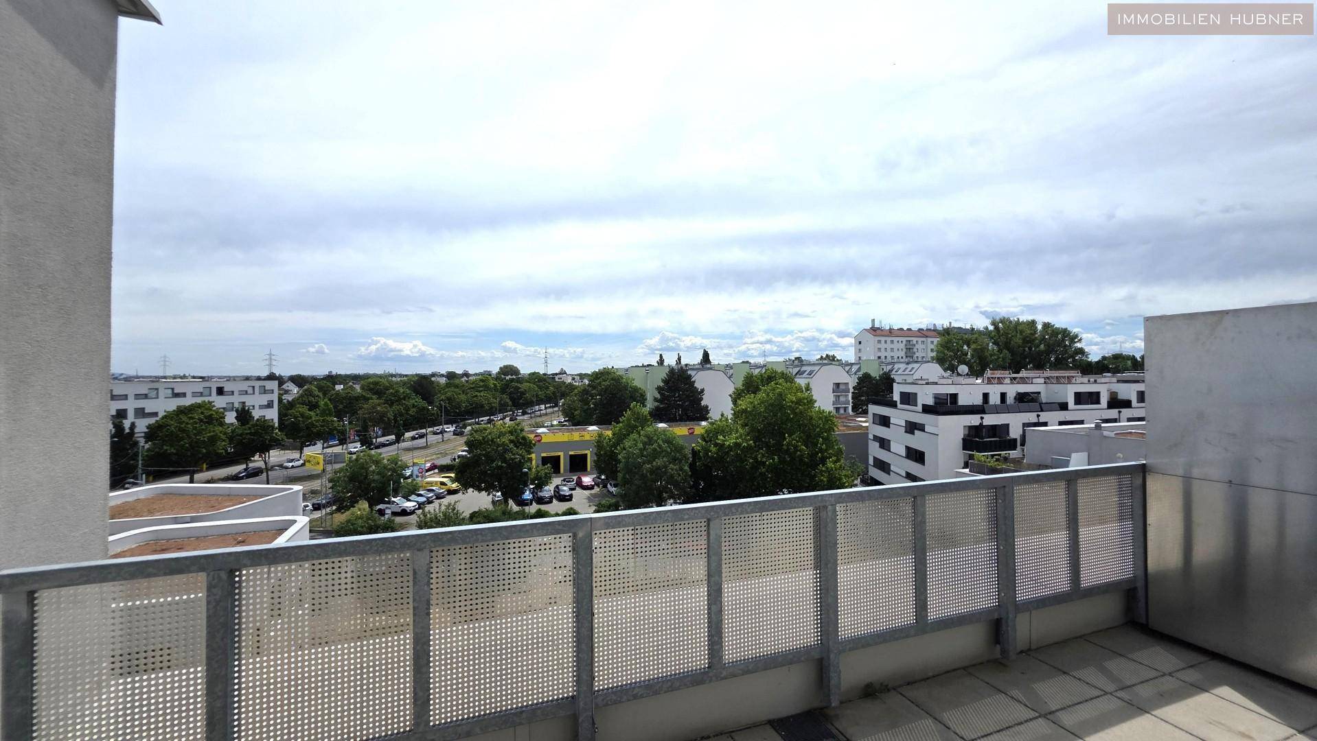 Weitläufiger Blick von der Terrasse über die Stadtlandschaft unter bewölktem Himmel.