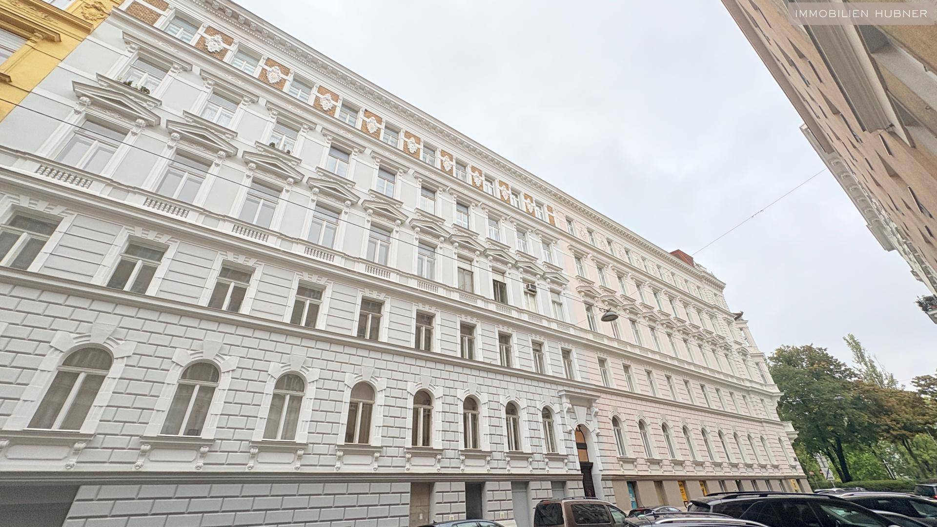 Historische Altbaufassade mit vielen Fenstern und architektonischen Details in der Stadt.