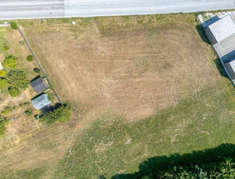 Draufsicht auf das weitläufige Grundstück mit angrenzender Straße und kleineren Nebengebäuden.