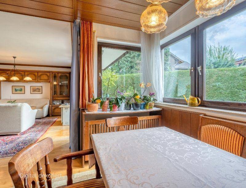 Heller Essbereich mit Holztisch und Stühlen, angrenzend an das Wohnzimmer mit Gartenblick.