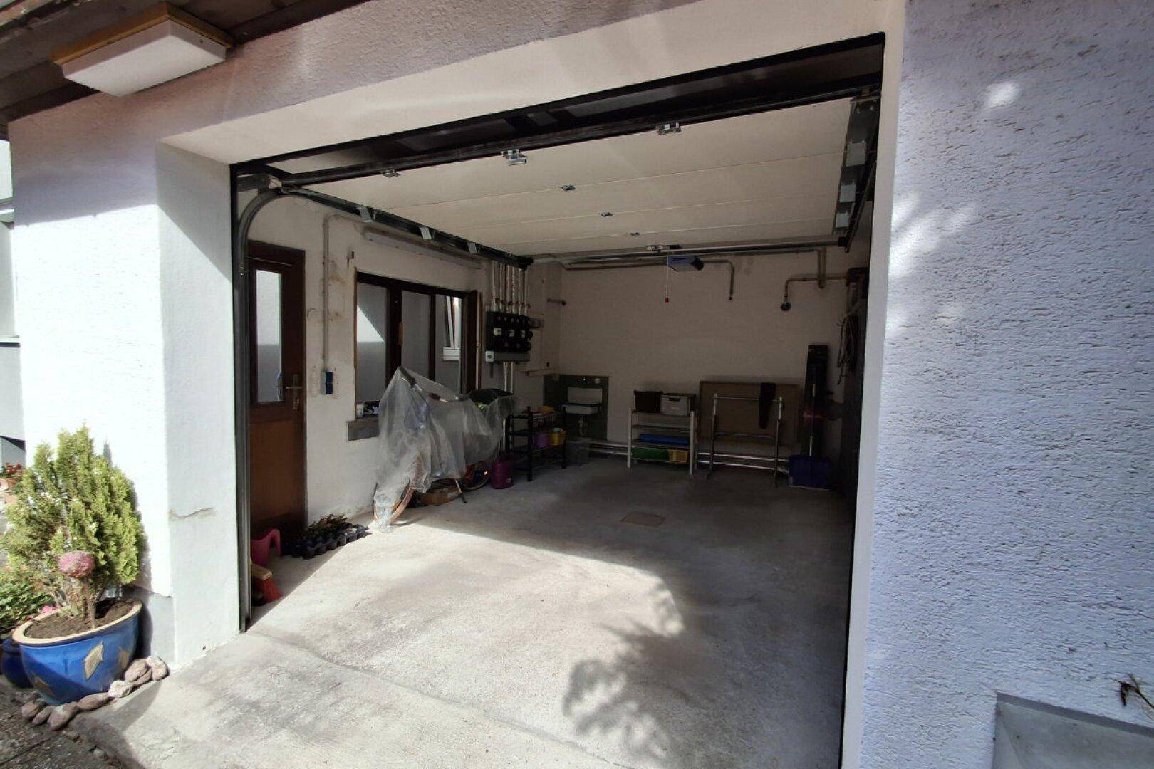 Geräumige Garage mit Betonboden und Platz für ein Fahrzeug.