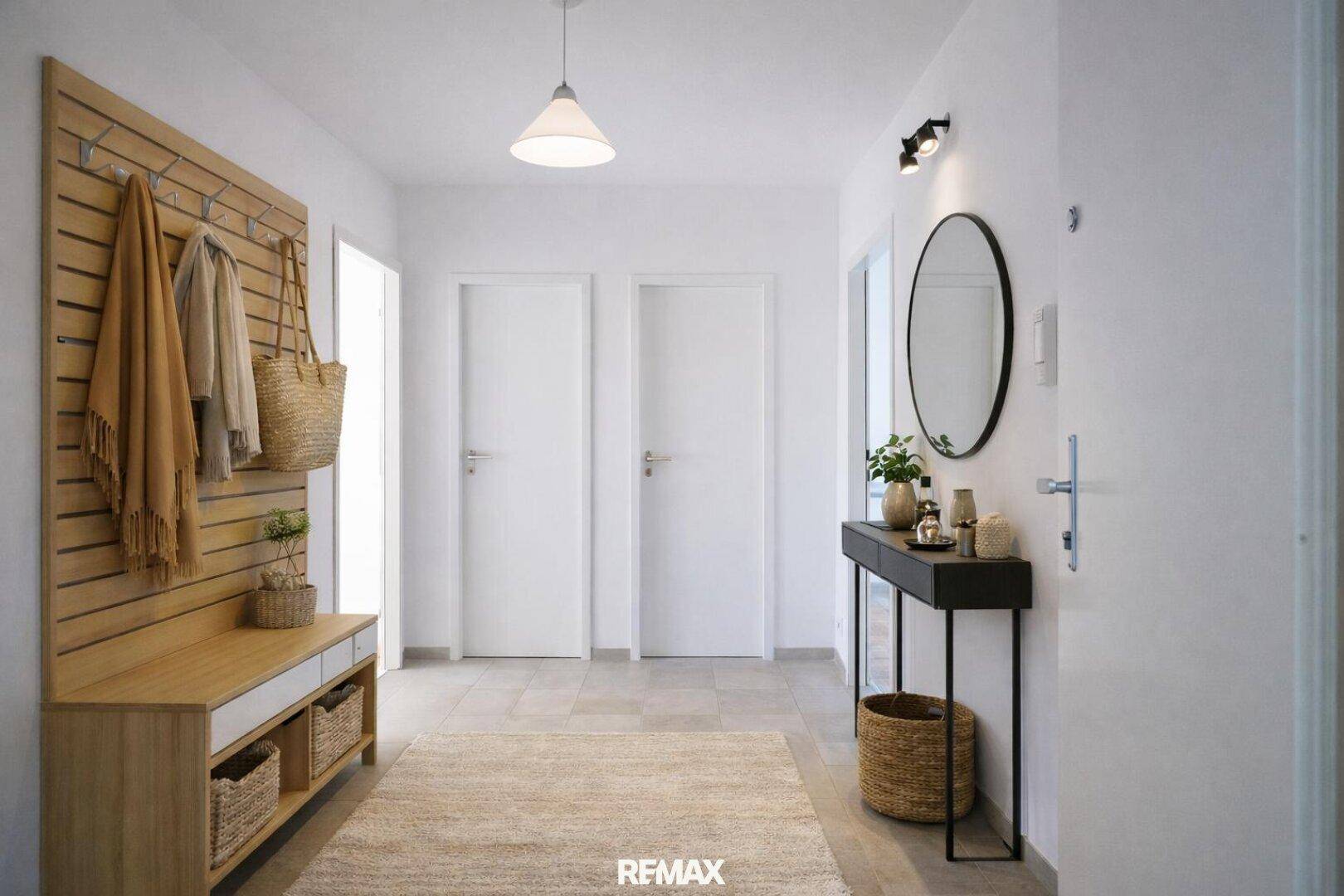 Heller Eingangsbereich mit Garderobe, Spiegel und Fliesenboden, modern und einladend gestaltet.