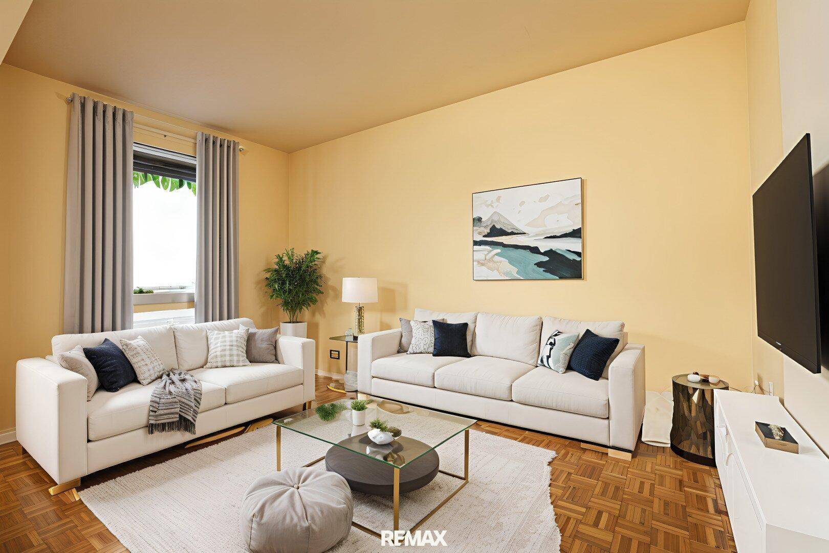 Gemütliches Wohnzimmer mit zwei Sofas, Couchtisch und Parkettboden in hellem Ambiente.