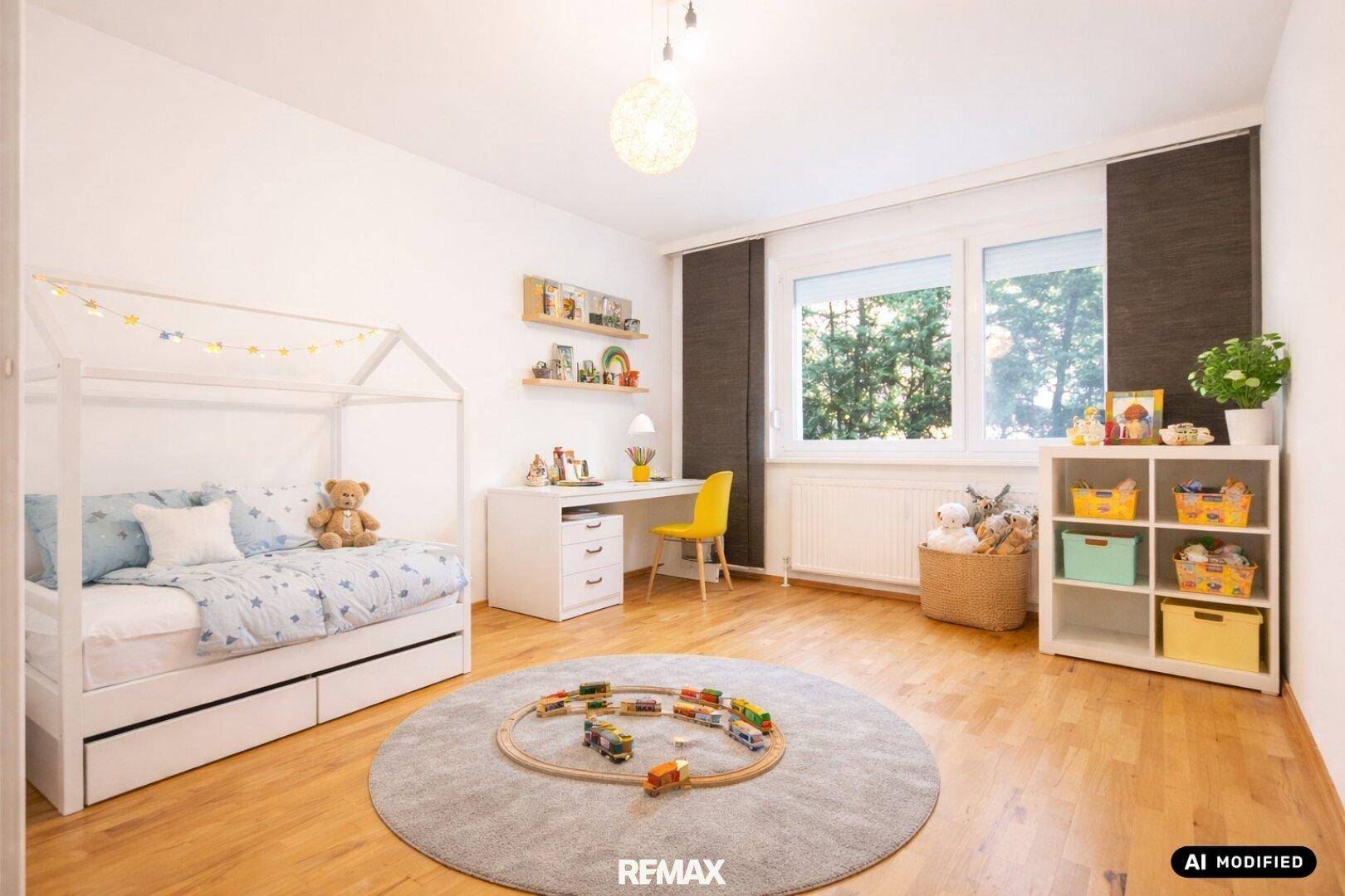 Freundliches Kinderzimmer mit Holzboden, Spielbett, Schreibtisch und Blick in den Garten.