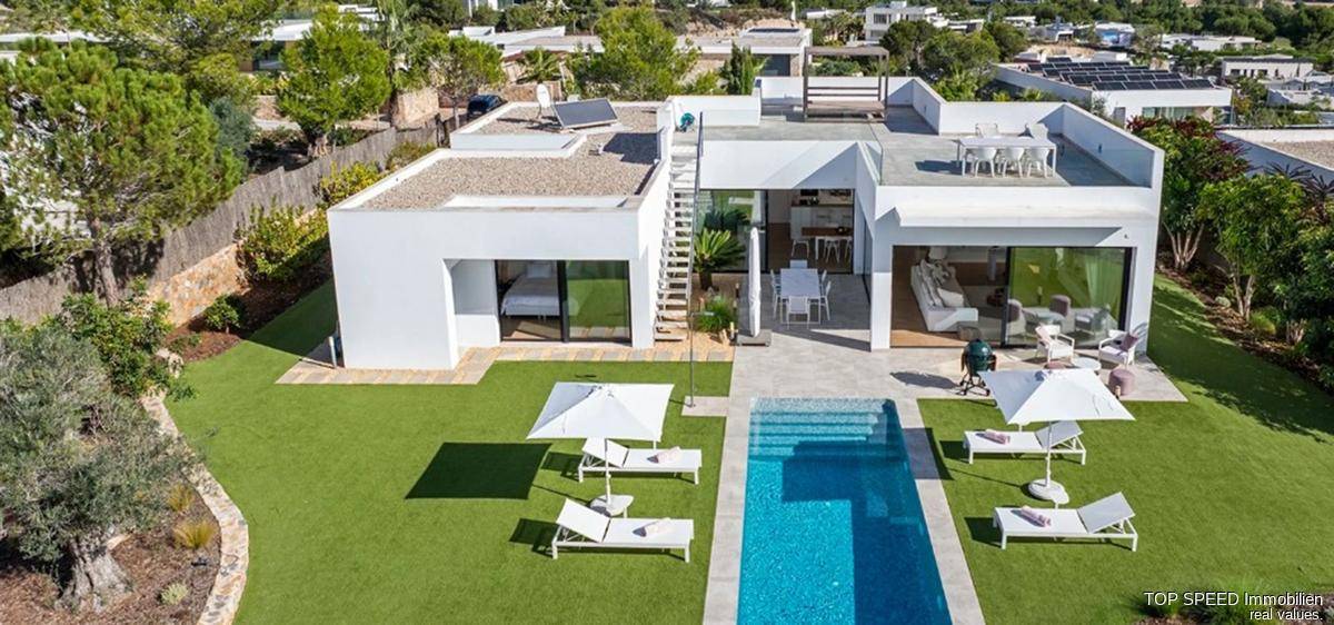 Luftaufnahme einer modernen Villa mit Pool, Garten und Dachterrasse in grüner Umgebung.