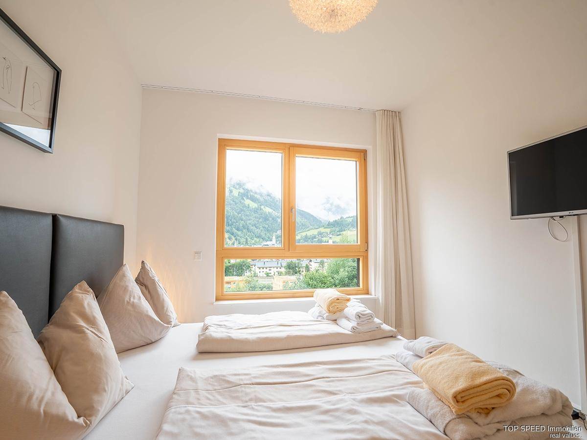 Schlafzimmer mit bequemen Betten und einem Fenster, das einen schönen Blick auf die Berge bietet.