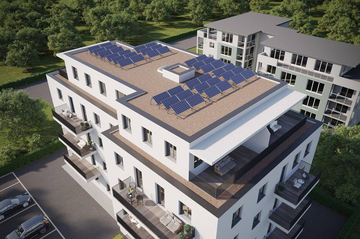 Luftaufnahme eines modernen Gebäudes mit Photovoltaikanlage auf dem Flachdach.