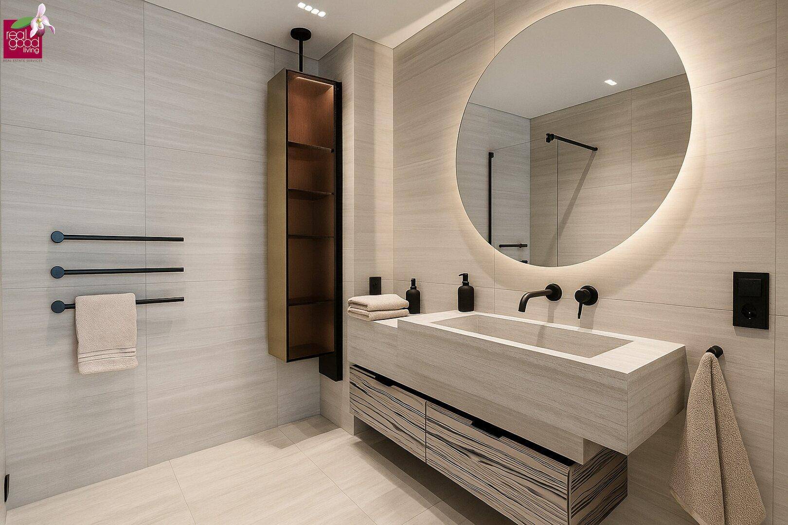 Elegantes Badezimmer mit modernem Waschtisch, beleuchtetem Spiegel und beheiztem Handtuchhalter.