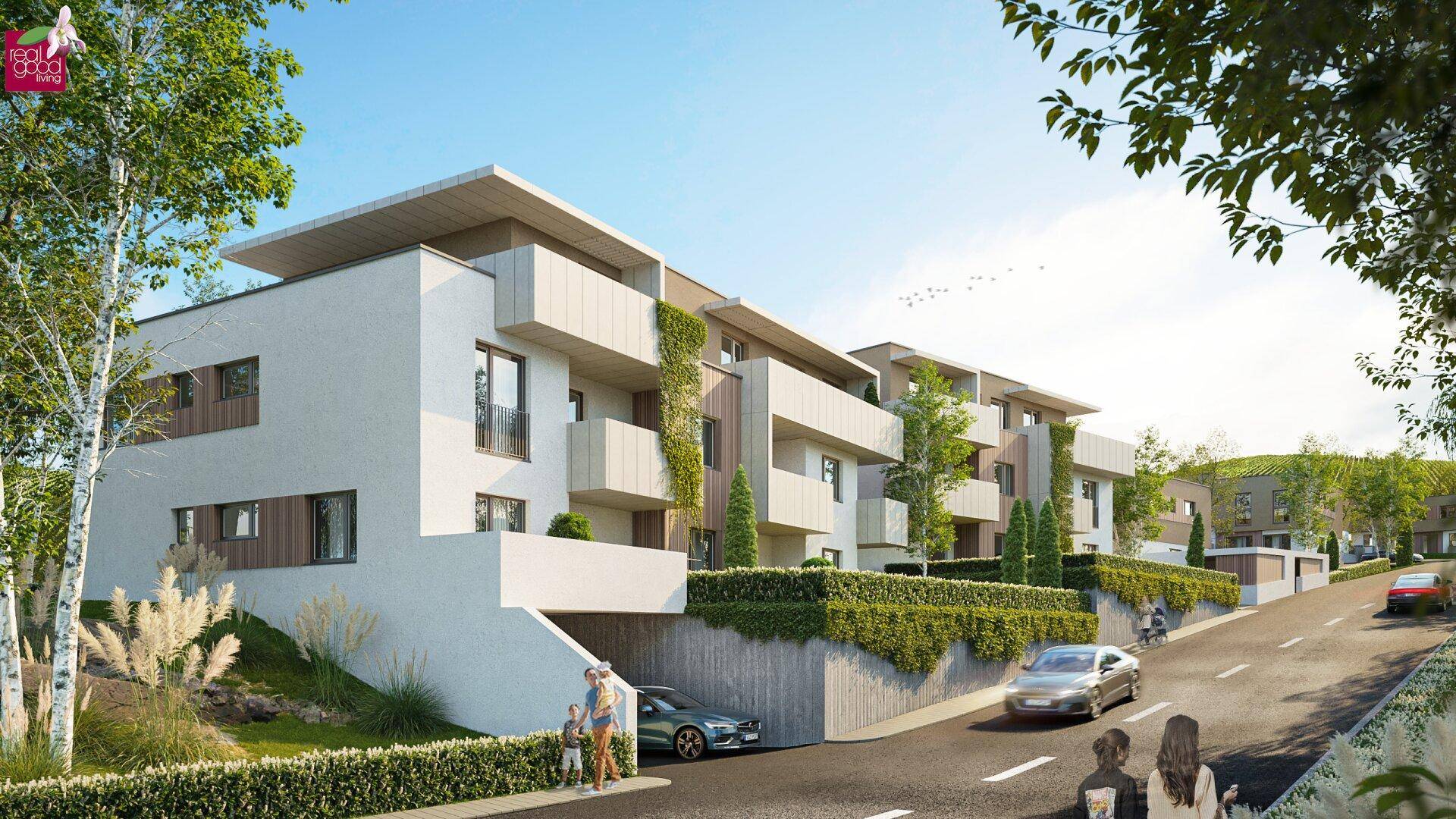 Moderne Wohngebäude mit Tiefgaragenzufahrt und Balkonen in einer grünen Umgebung.