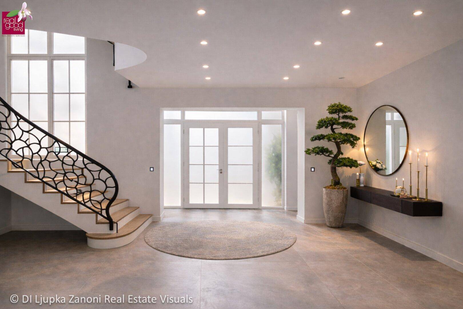 Eleganter Eingangsbereich mit geschwungener Treppe, hohen Decken und modernem Design.