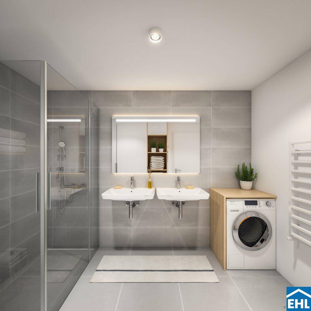 Modernes Badezimmer mit Doppelwaschbecken, begehbarer Dusche und Waschmaschine.