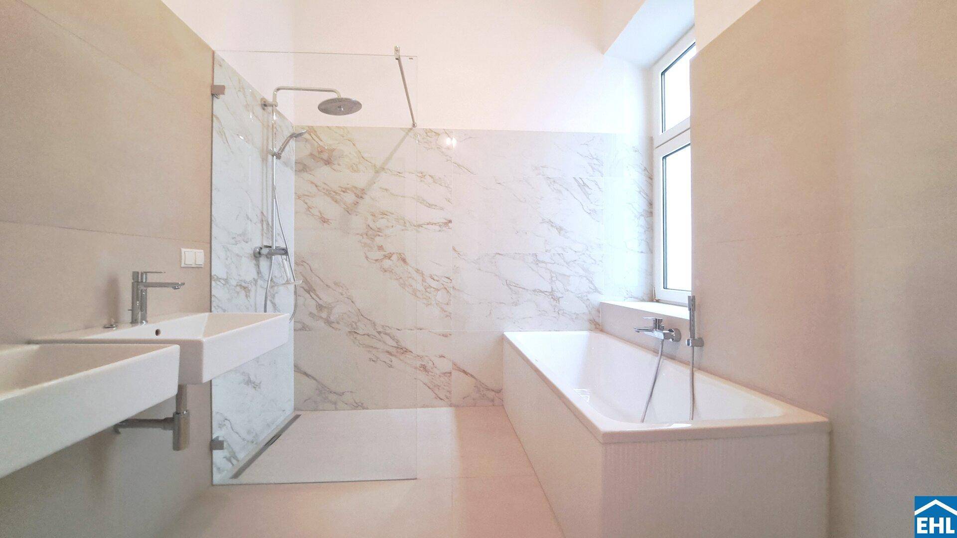 Geräumiges, modernes Badezimmer mit Badewanne, begehbarer Dusche und Fenster für Tageslicht.
