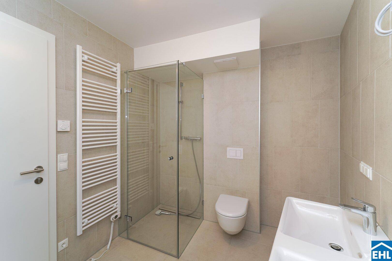 Zeitgemäßes Badezimmer mit begehbarer Dusche, wandhängendem WC und Einzelwaschbecken.