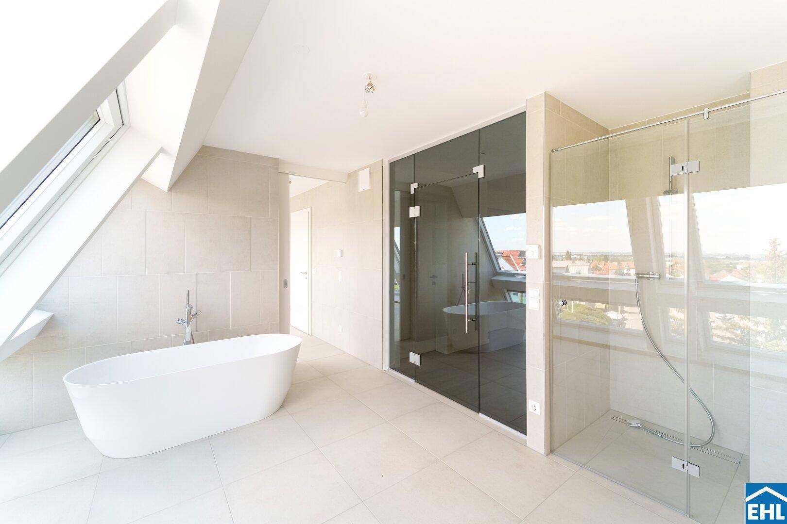 Modernes Badezimmer mit freistehender Badewanne, großer begehbarer Dusche und Dachfenster.
