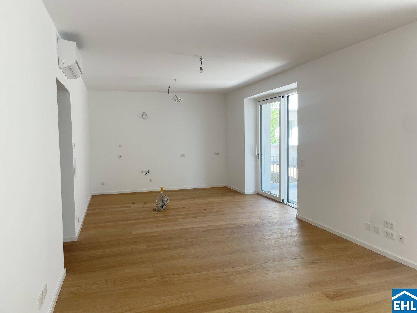 Geräumiges, helles Zimmer mit Parkettboden und vorbereiteten Anschlüssen für die Einrichtung.