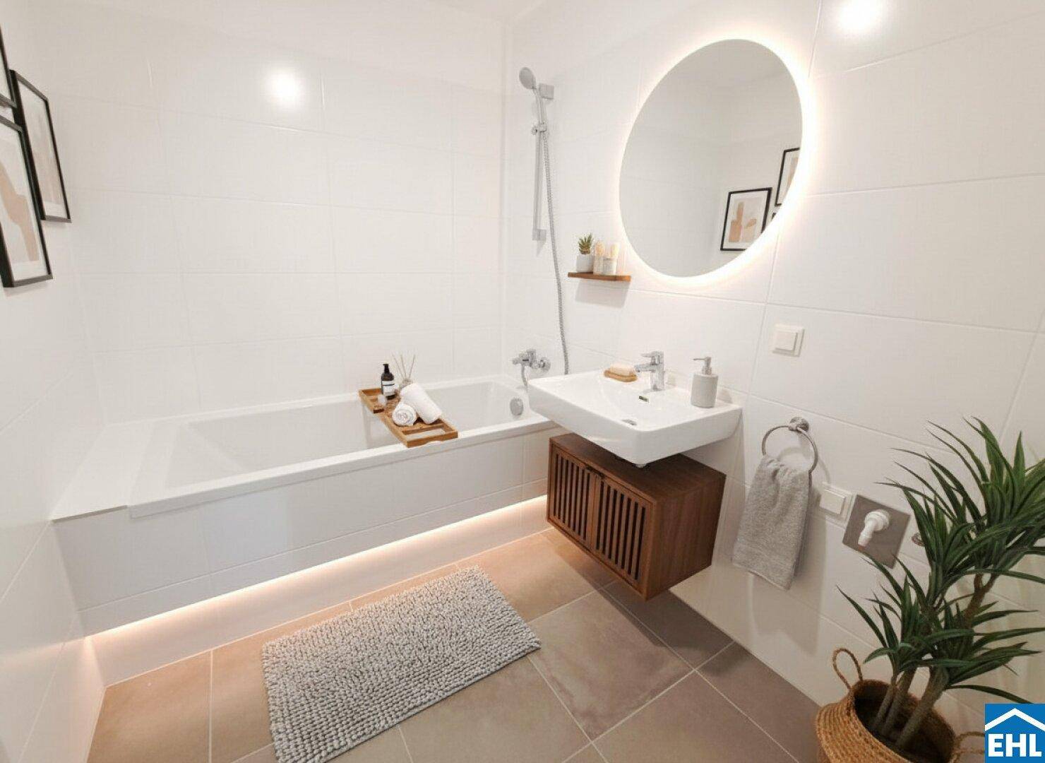 Modernes Badezimmer mit Badewanne, beleuchtetem Spiegel und stilvollen weißen Wandfliesen.