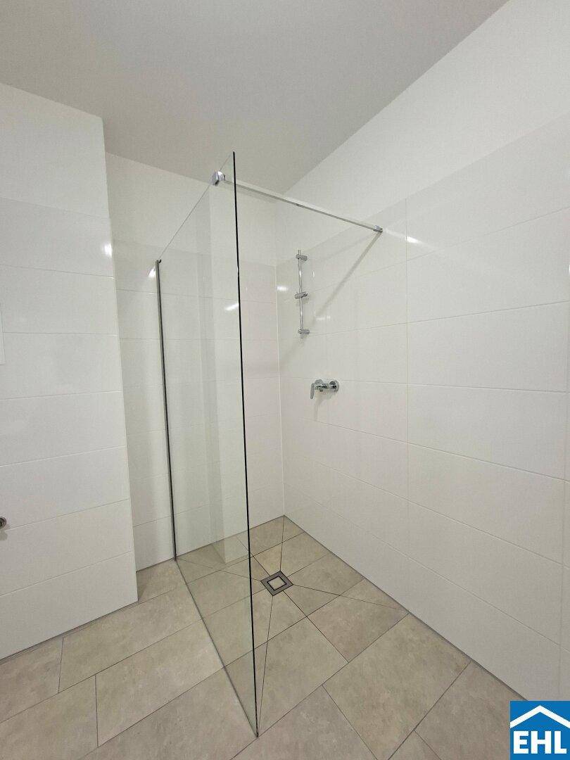 Bodengleiche Dusche mit Glasabtrennung und modernen Fliesen, bietet Komfort und Stil im Badezimmer.