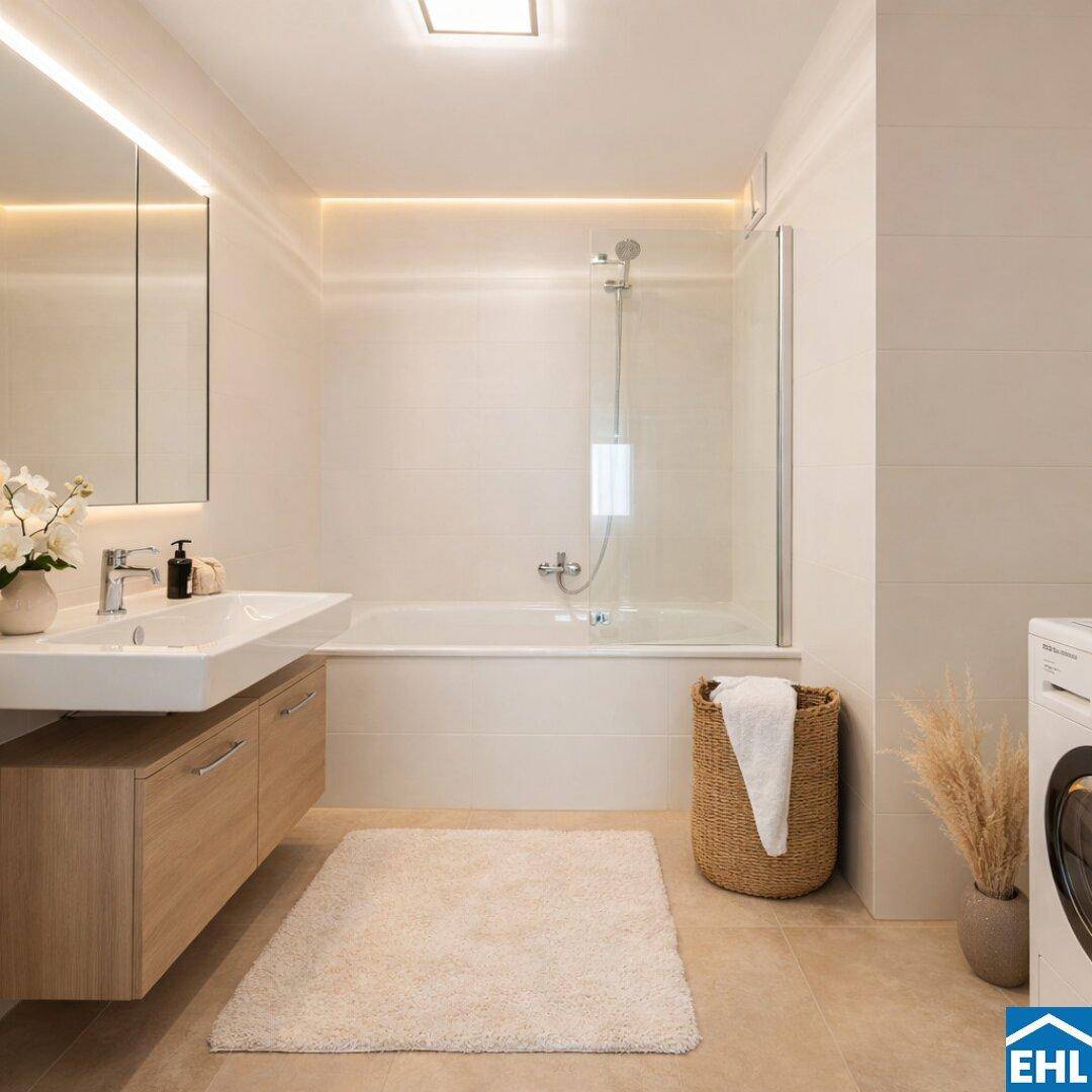 Modernes Badezimmer mit Badewanne, Duschabtrennung, Einzelwaschbecken und integrierter Waschmaschine.