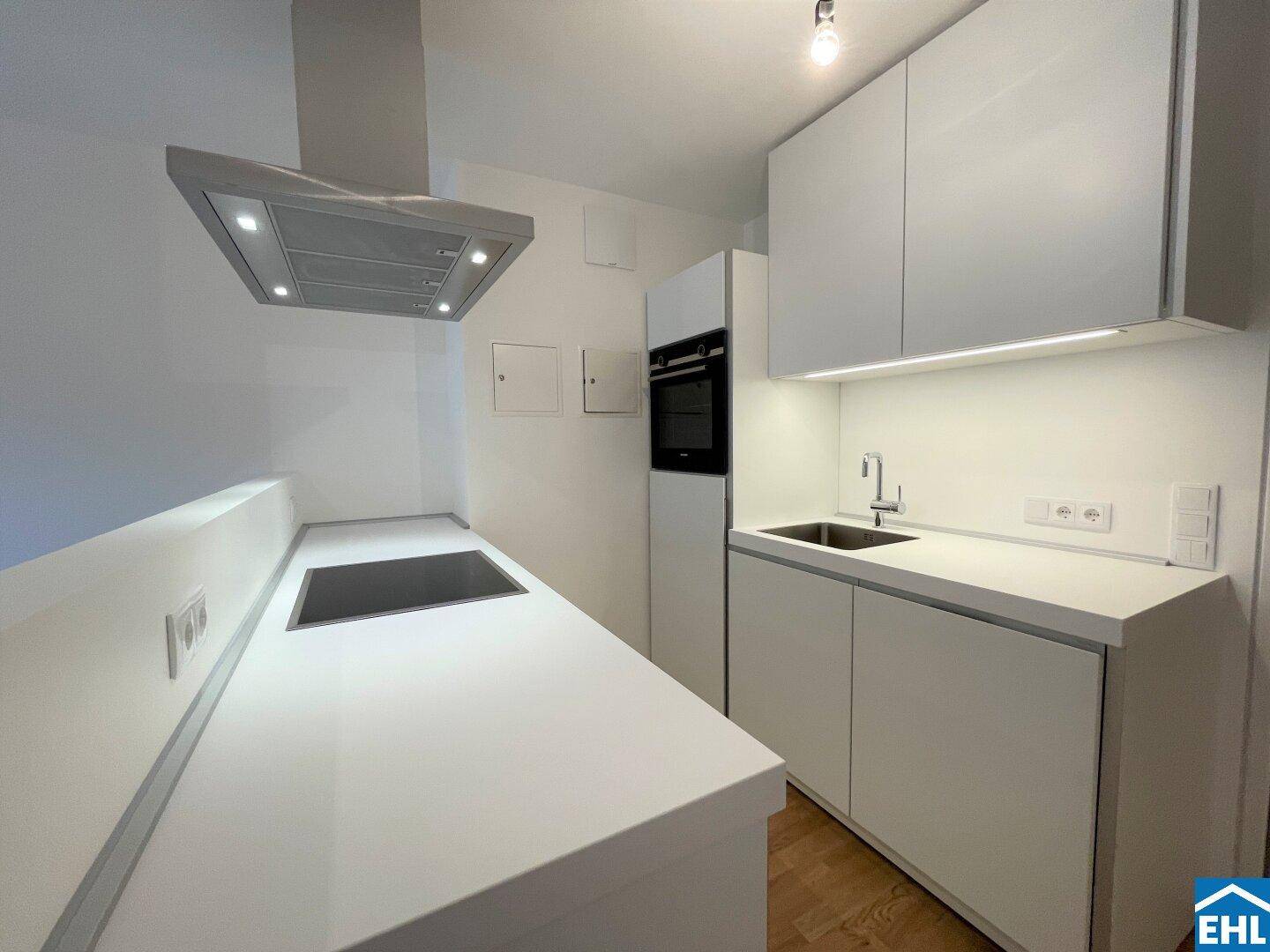 Neue, weiße Einbauküche mit integriertem Backofen und viel Stauraum für eine moderne Wohnatmosphäre.