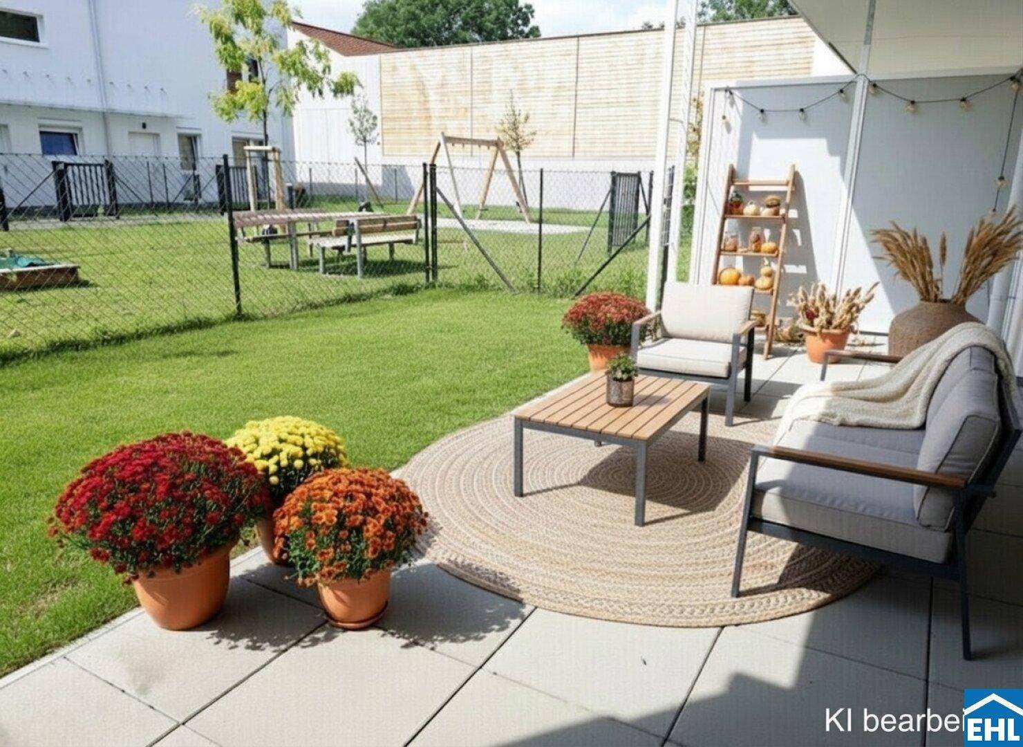 Gemütliche Terrasse mit Sitzgelegenheiten und bunten Blumen, angrenzend an eine Rasenfläche.