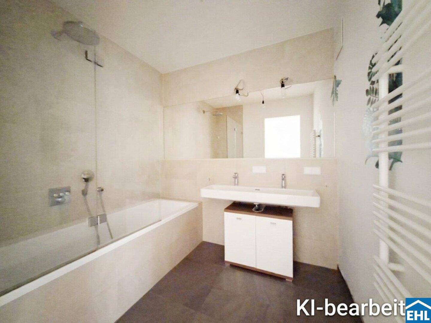 Modernes Badezimmer mit Badewanne, Doppelwaschbecken und beheiztem Handtuchhalter.