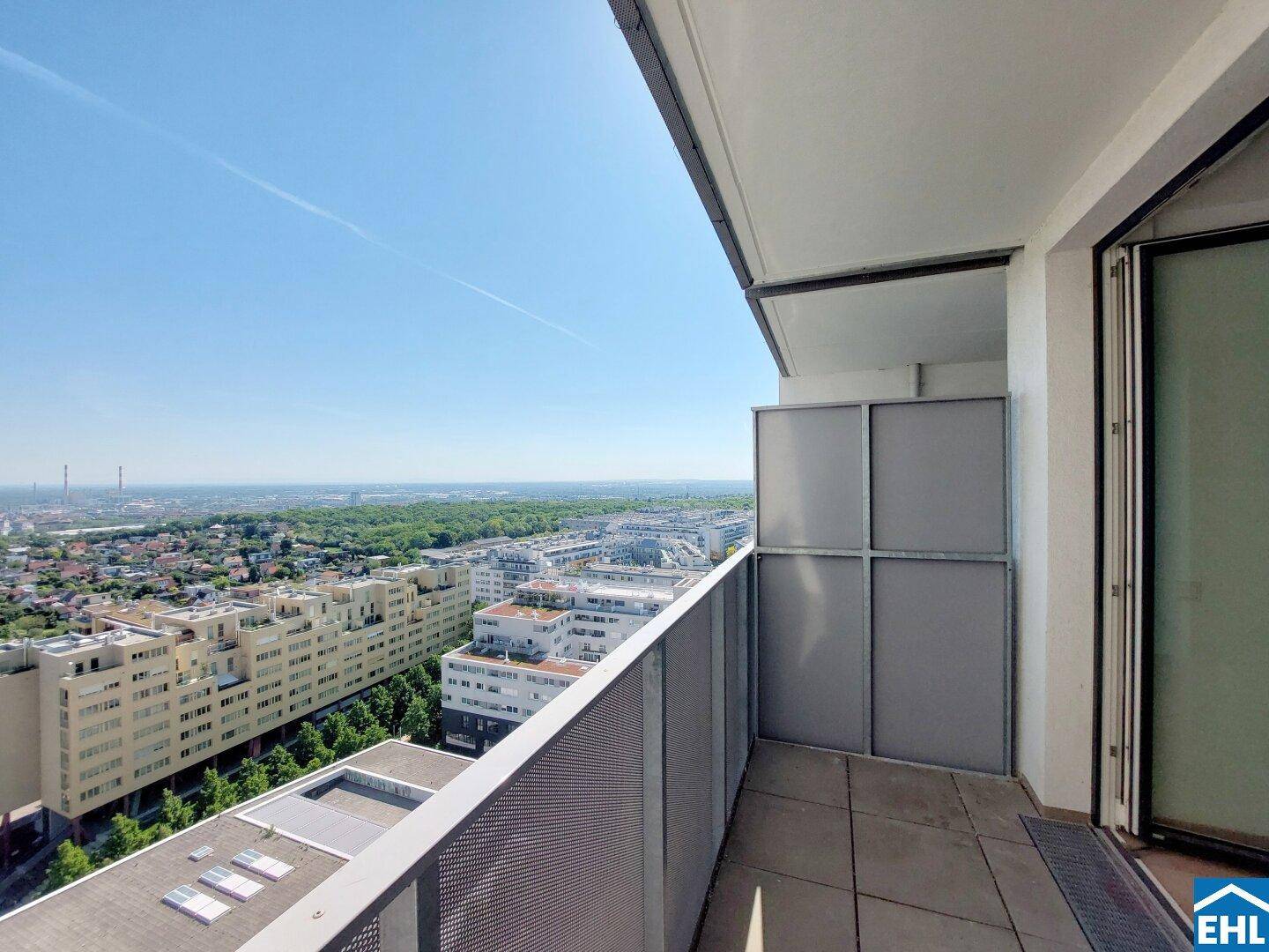 Geräumiger Balkon mit Fliesenboden und Metallgeländer, der einen beeindruckenden Panoramablick über die Stadt bietet.