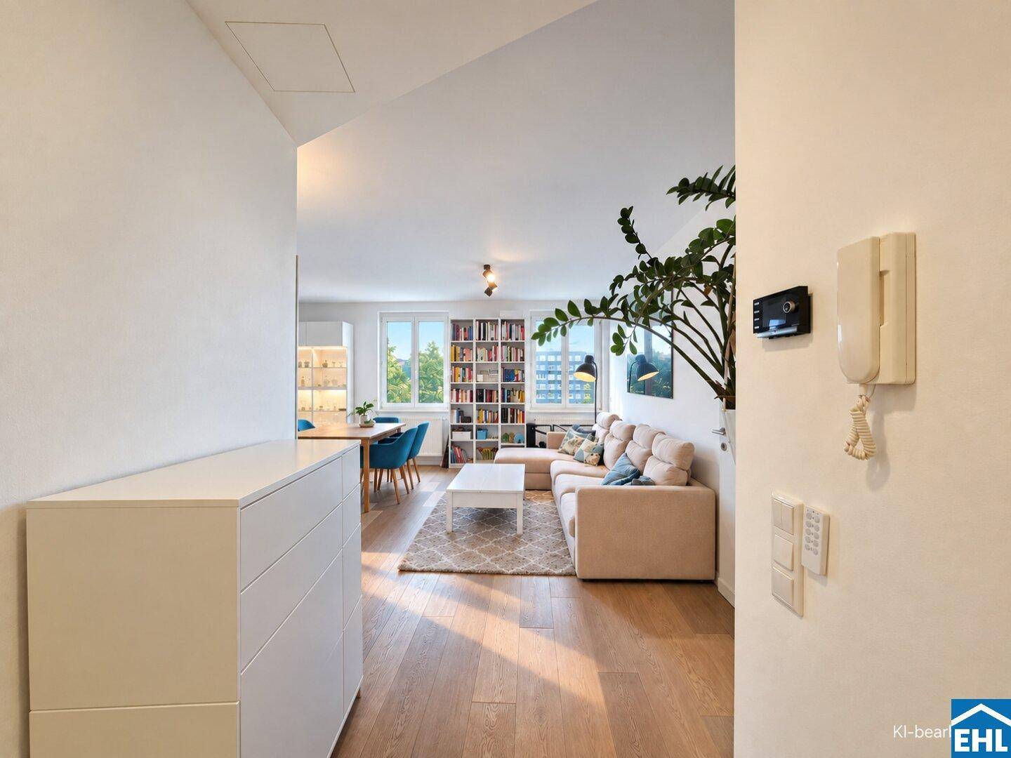 Heller Flur mit Blick in den offenen Wohnbereich, ausgestattet mit Holzboden und modernen Möbeln.