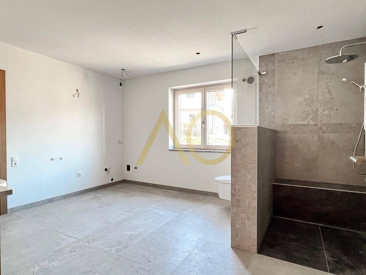 Helles, modernes Badezimmer mit ebenerdiger Dusche, Wand-WC und Fenster für Tageslicht.