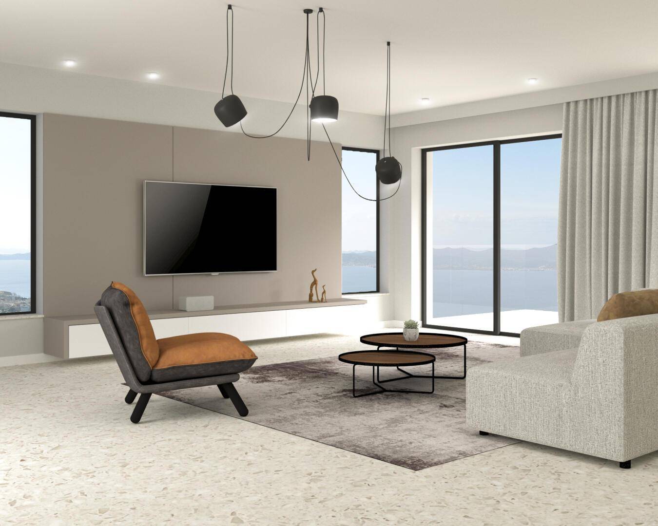 Geräumiges Wohnzimmer mit großen Fenstern, die einen weiten Blick auf das Meer bieten.
