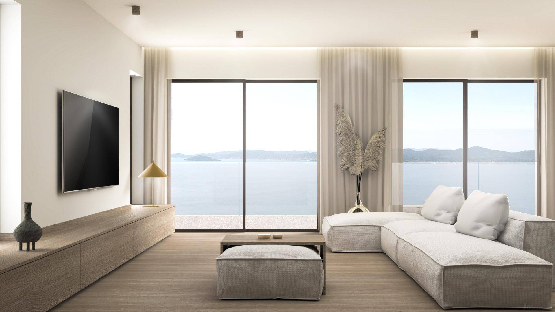 Lichtdurchflutetes Wohnzimmer mit Panoramablick auf das Meer und moderne Einrichtungselemente.