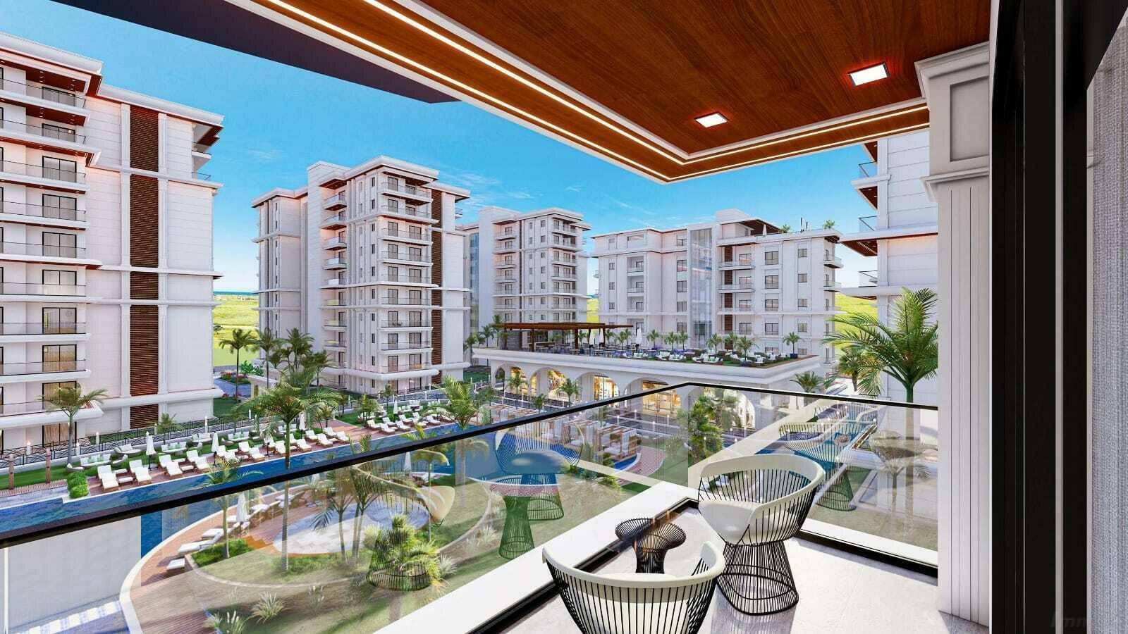 Geräumiger Balkon mit Sitzgelegenheiten und Panoramablick auf die gesamte Wohnanlage.