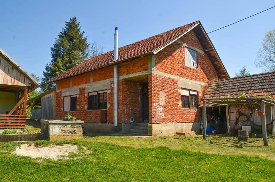 Ziegelhaus in ländlicher Umgebung, das sich in einem Zustand der Renovierung oder des Ausbaus befindet.