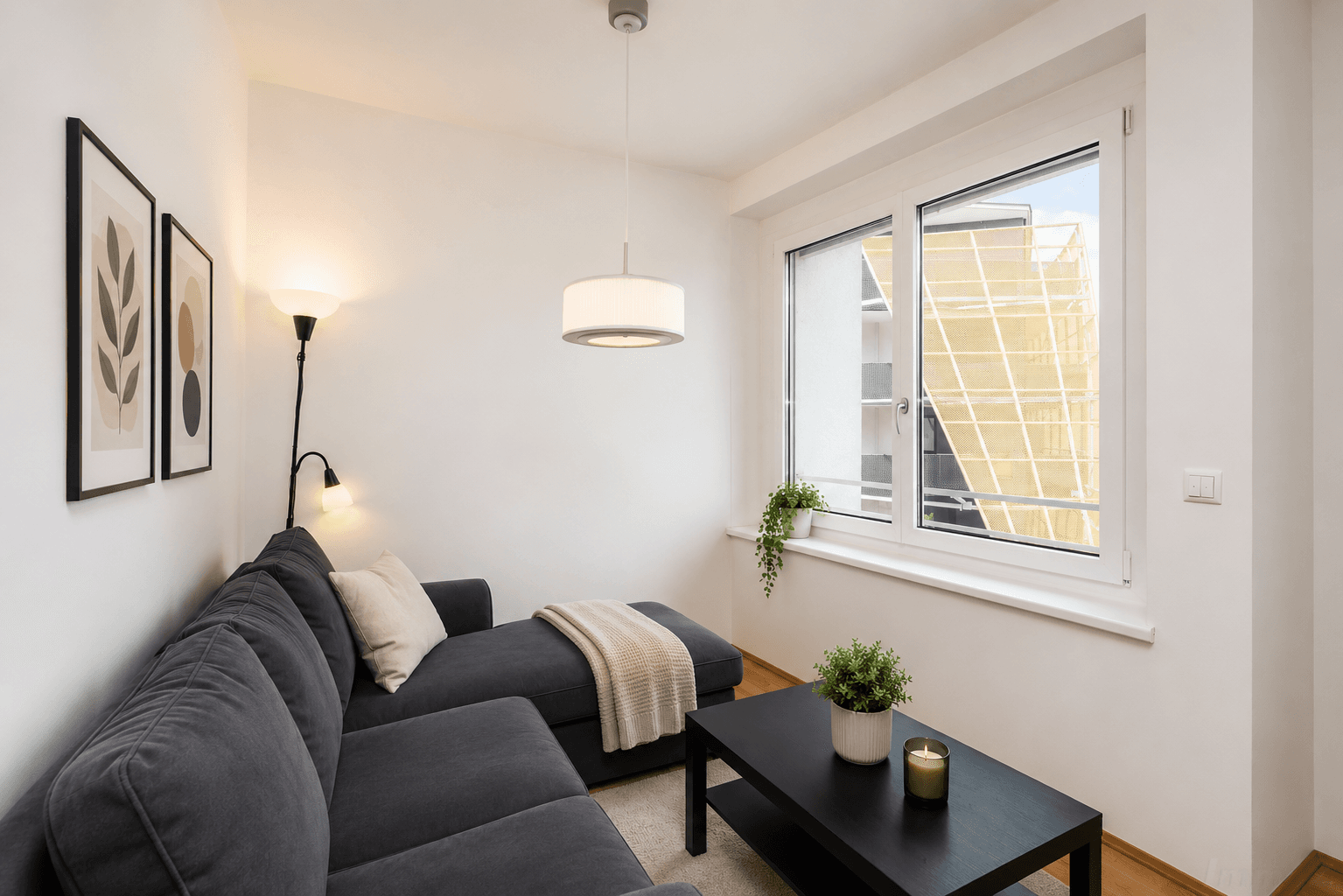 Gemütliches Wohnzimmer mit großem Sofa, modernem Dekor und Blick nach draußen.