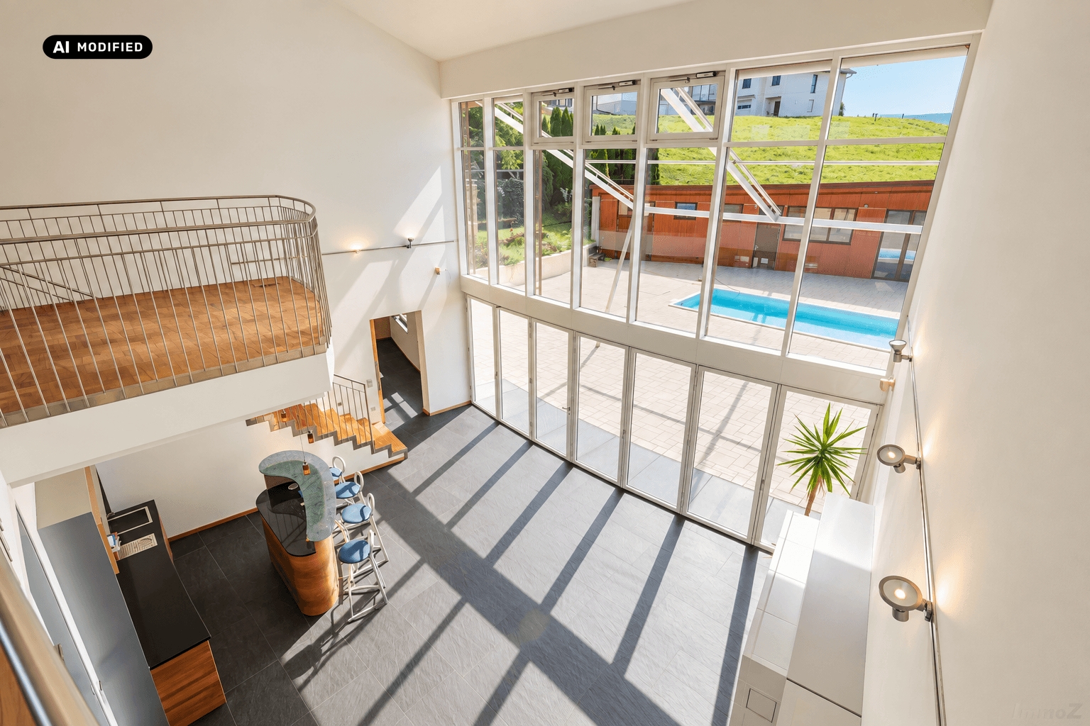 Offener Wohnbereich mit hohen Decken, großen Fensterfronten und Blick auf den Pool und die grüne Umgebung.