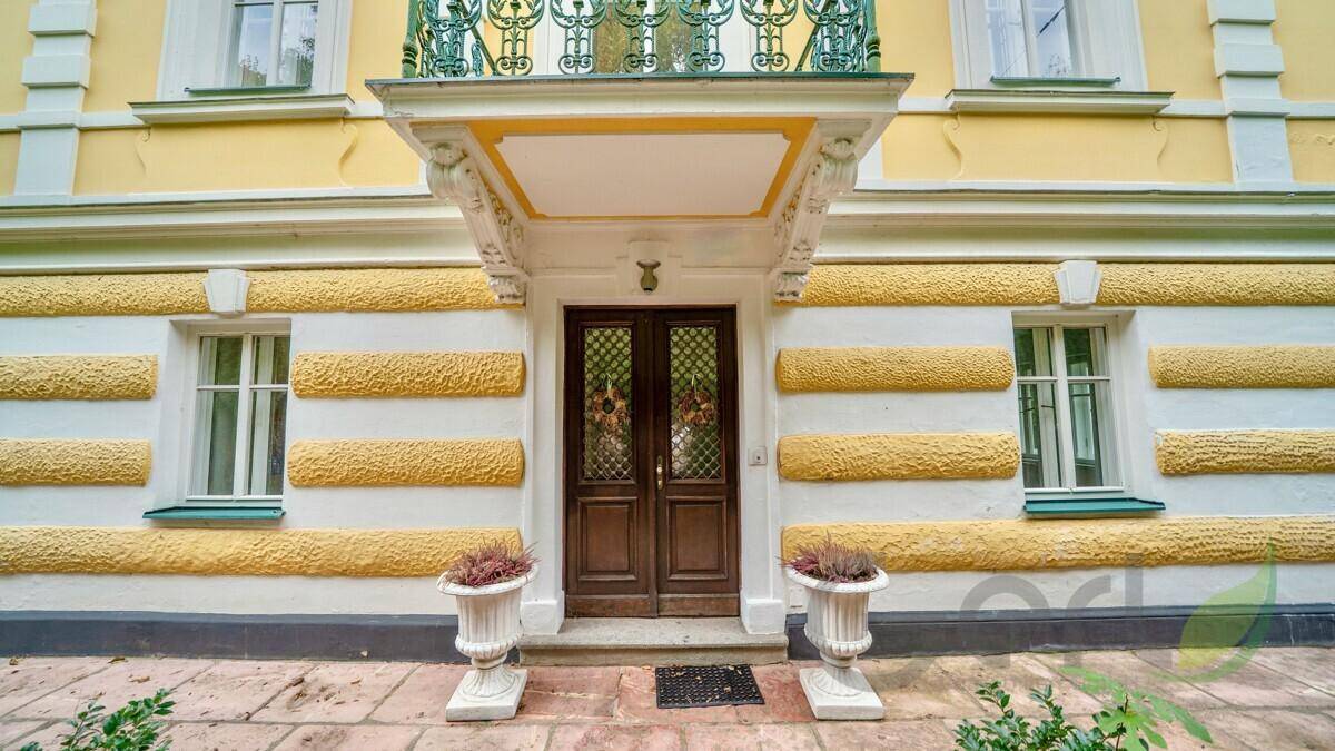 Repräsentativer Eingangsbereich der Villa mit verzierten Türen und klassischer Fassadengestaltung.