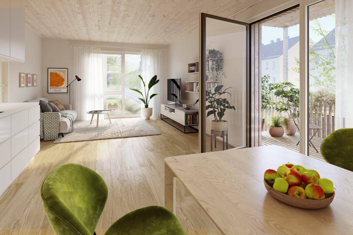 Heller, offener Wohn-Essbereich mit Holzboden, hohen Decken und Zugang zu einem Balkon.