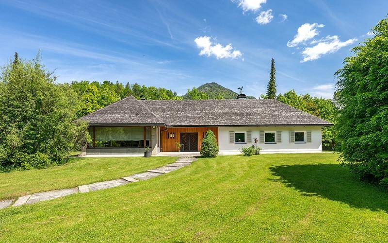 Charmantes Einfamilienhaus mit weitläufigem Vorgarten und traditionellem Dach in ländlicher Umgebung.