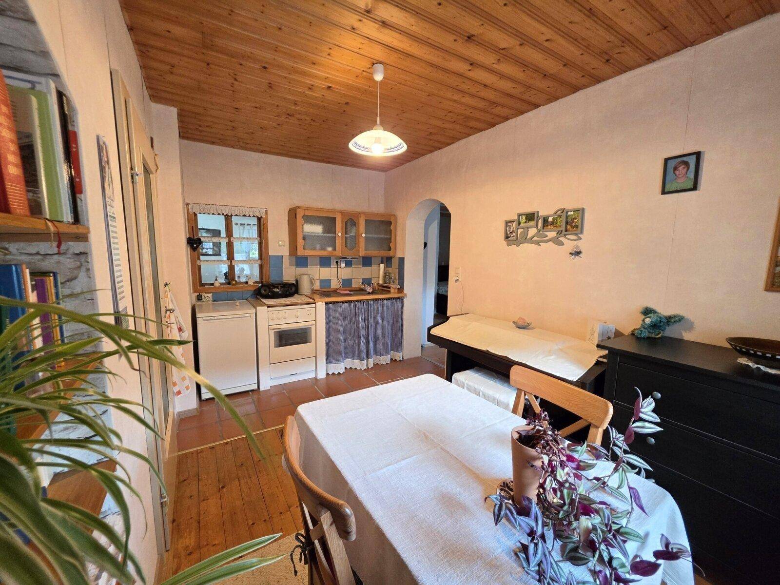 Traditionelle Küche mit Essbereich, Holzdecke und einfacher, funktionaler Ausstattung.