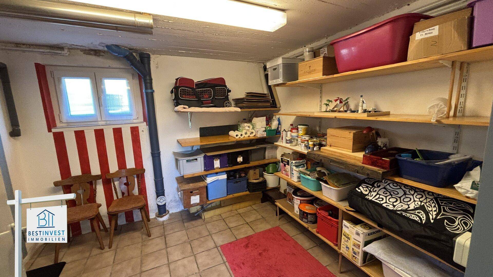 Geräumiger Abstellraum mit vielen Regalen, Fliesenboden und kleinem Fenster.