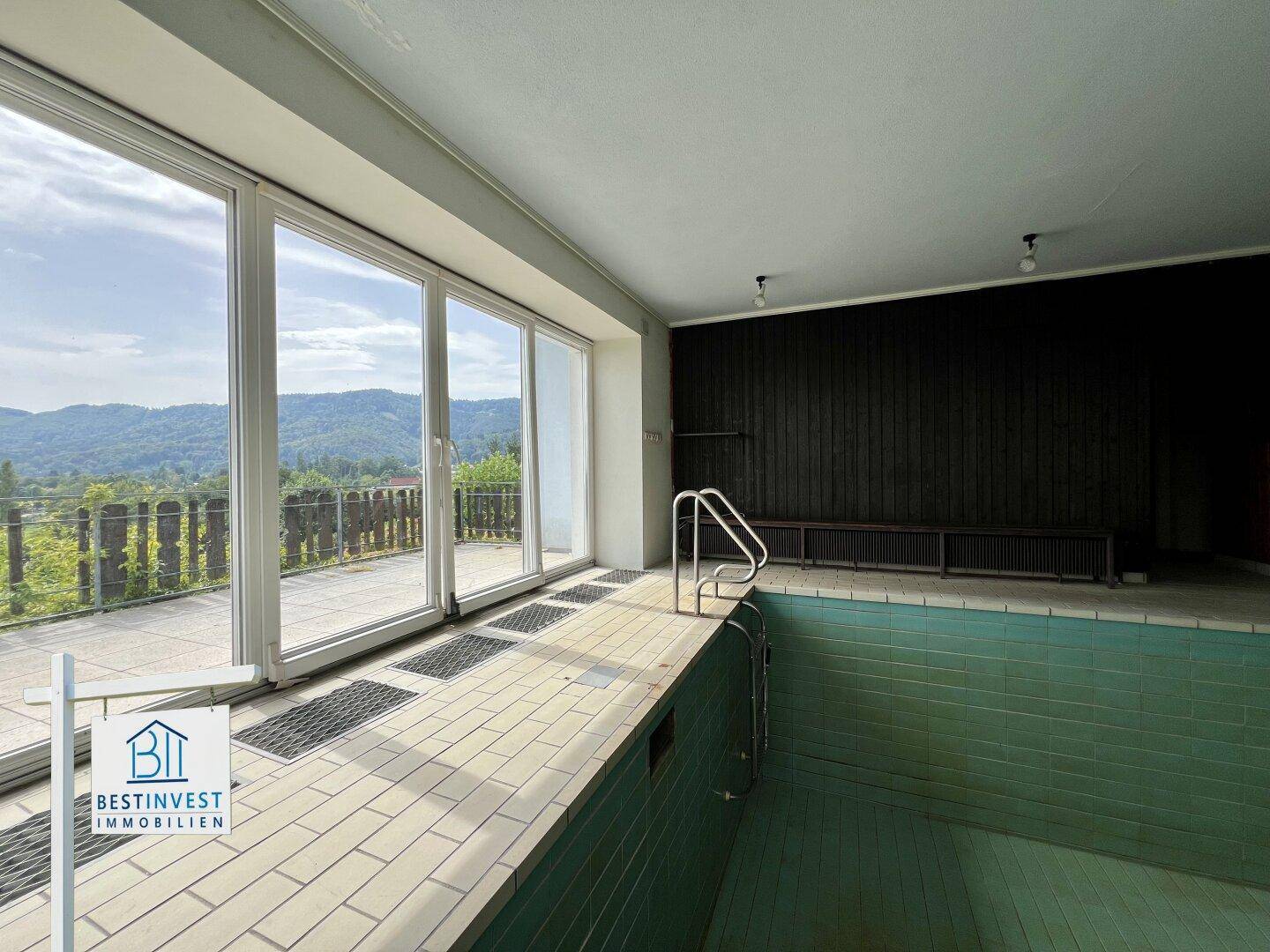 Innenpool mit großen Schiebetüren, die Zugang zur Terrasse und Aussicht bieten.
