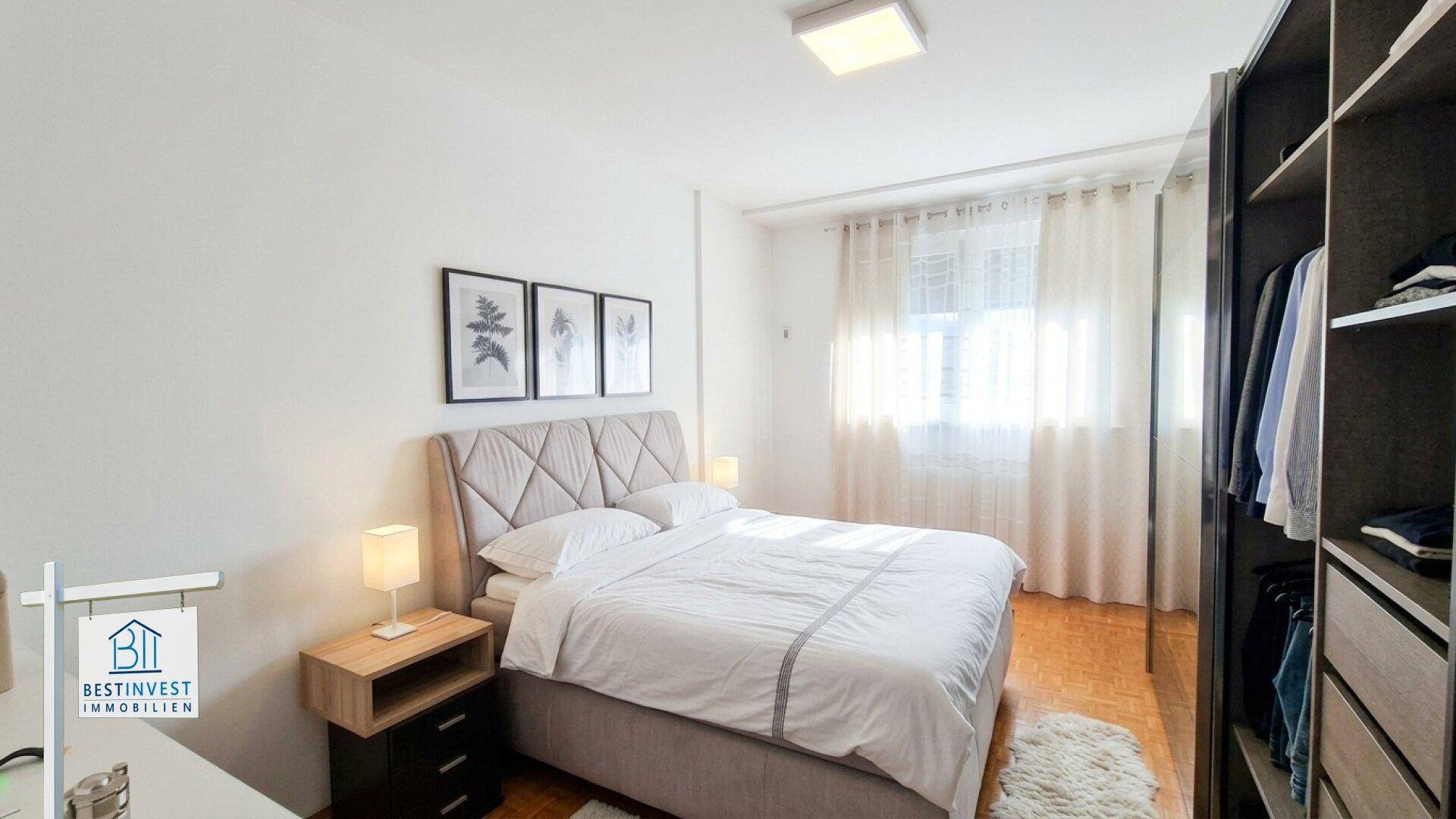 Gemütliches Schlafzimmer mit Doppelbett, Einbauschrank und hellem Parkettboden.