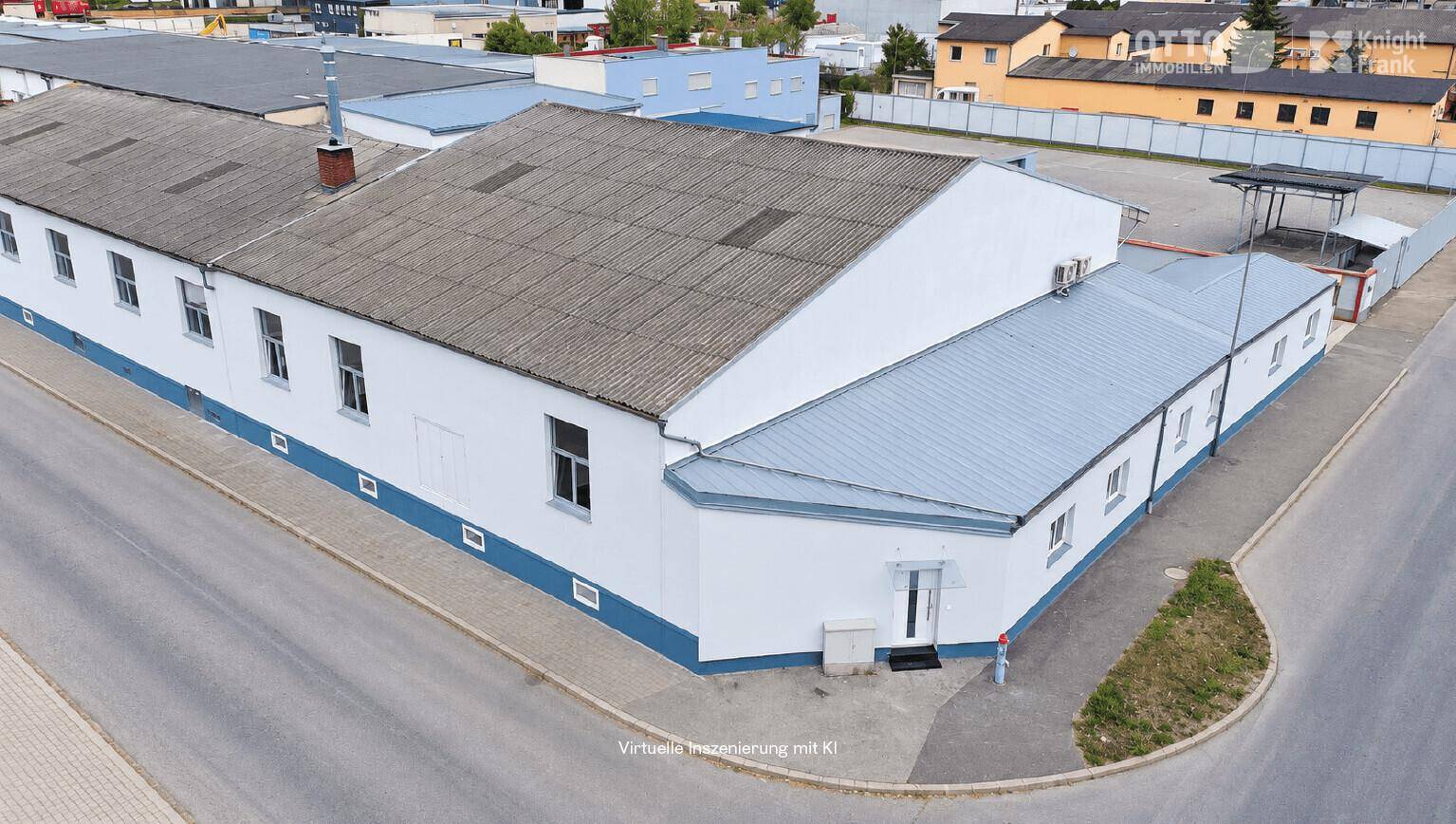 Luftaufnahme des gesamten Gewerbekomplexes mit mehreren Gebäudeteilen und umliegenden Straßen.
