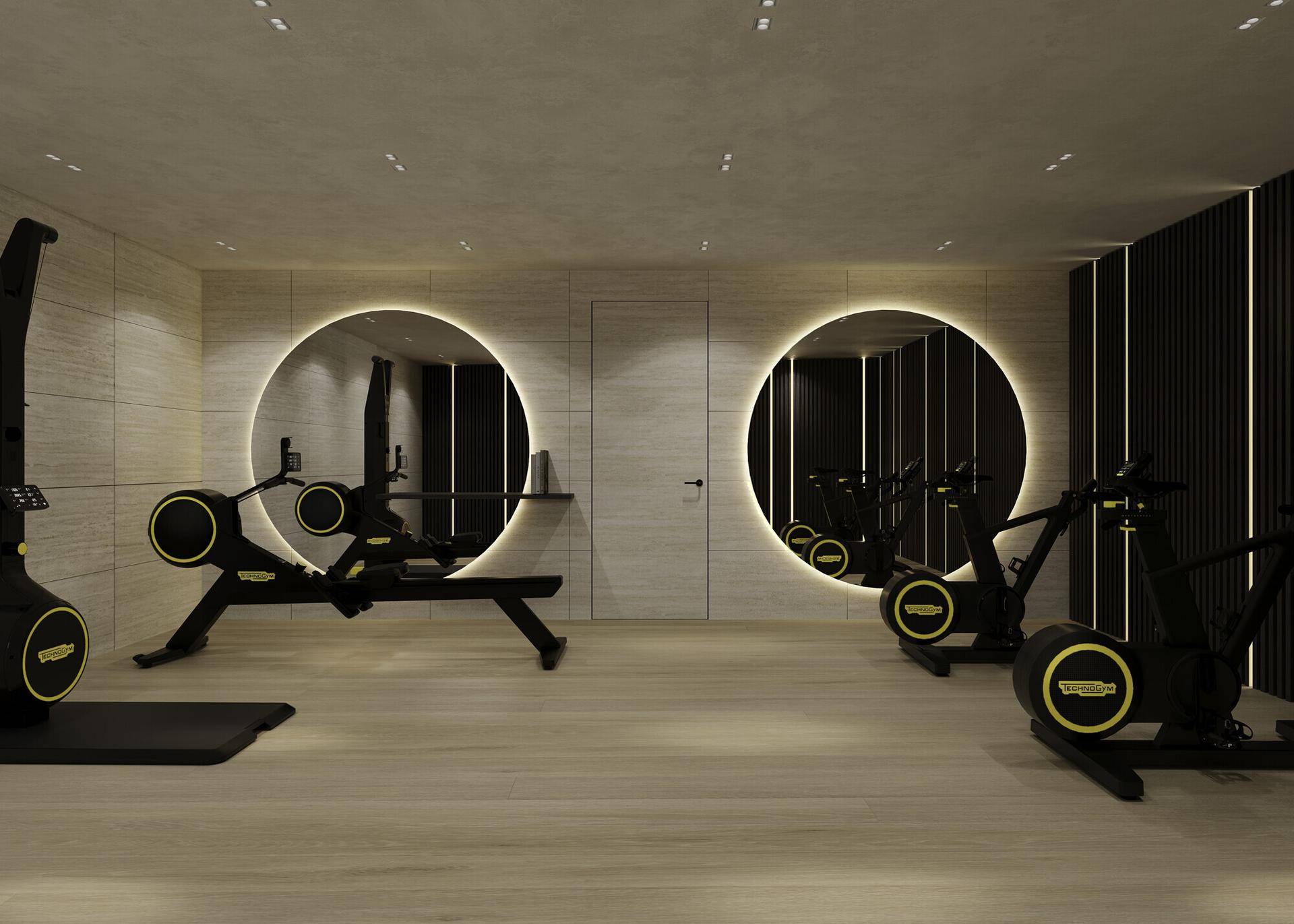 Moderner Fitnessraum mit Rudergeräten, Fahrrädern und dekorativen runden Spiegeln.