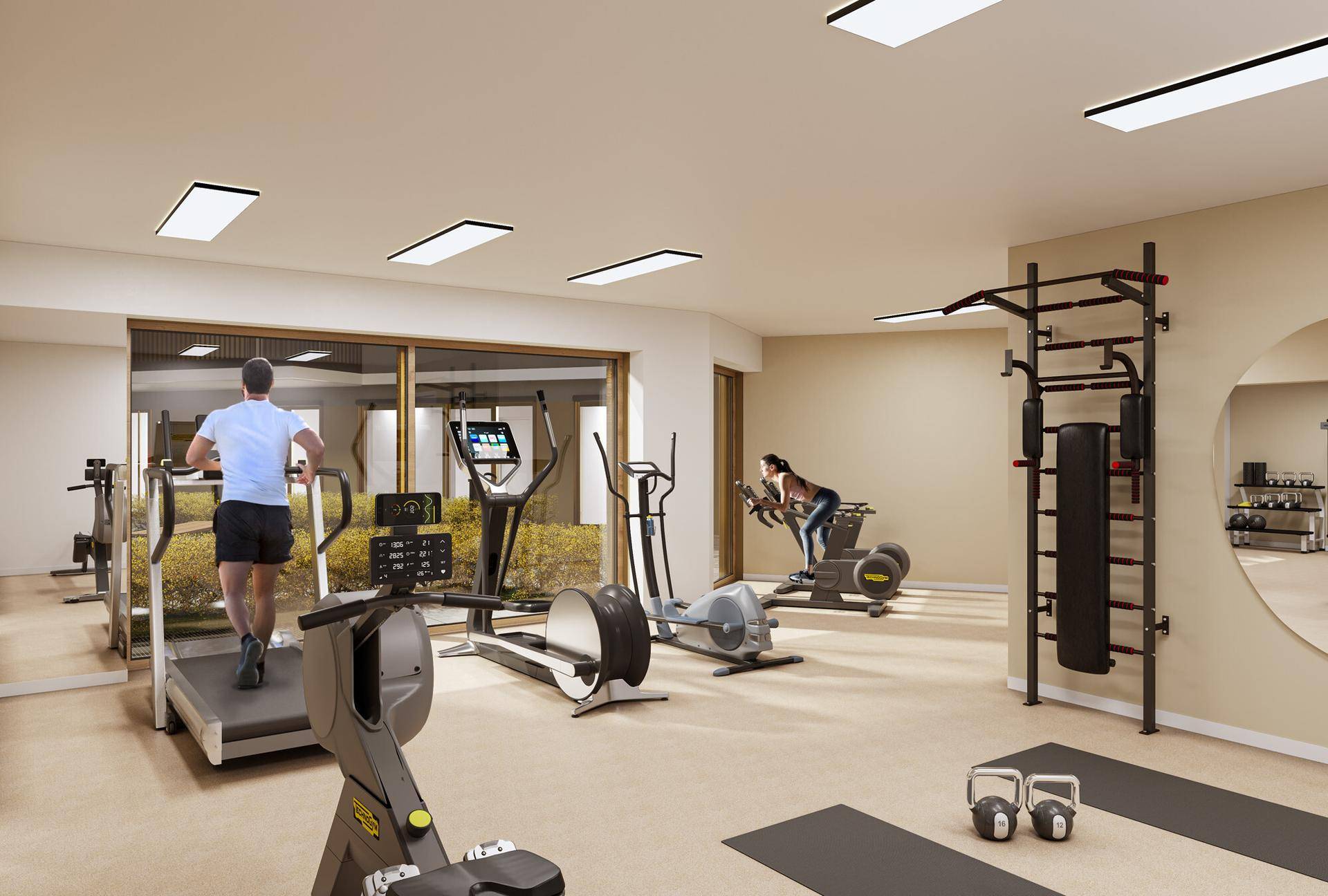 Moderner Fitnessraum mit verschiedenen Trainingsgeräten und großen Fenstern.