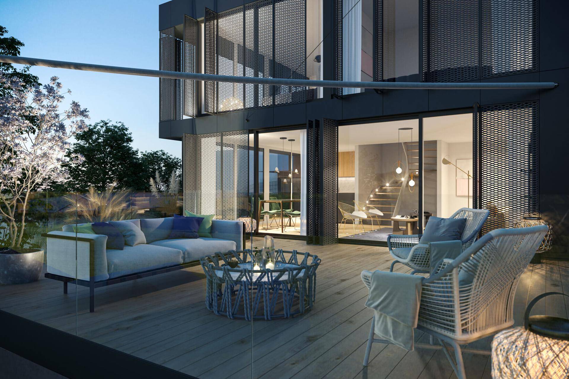 Gemütliche Terrasse mit modernen Lounge-Möbeln und Blick in den hellen Wohnbereich.