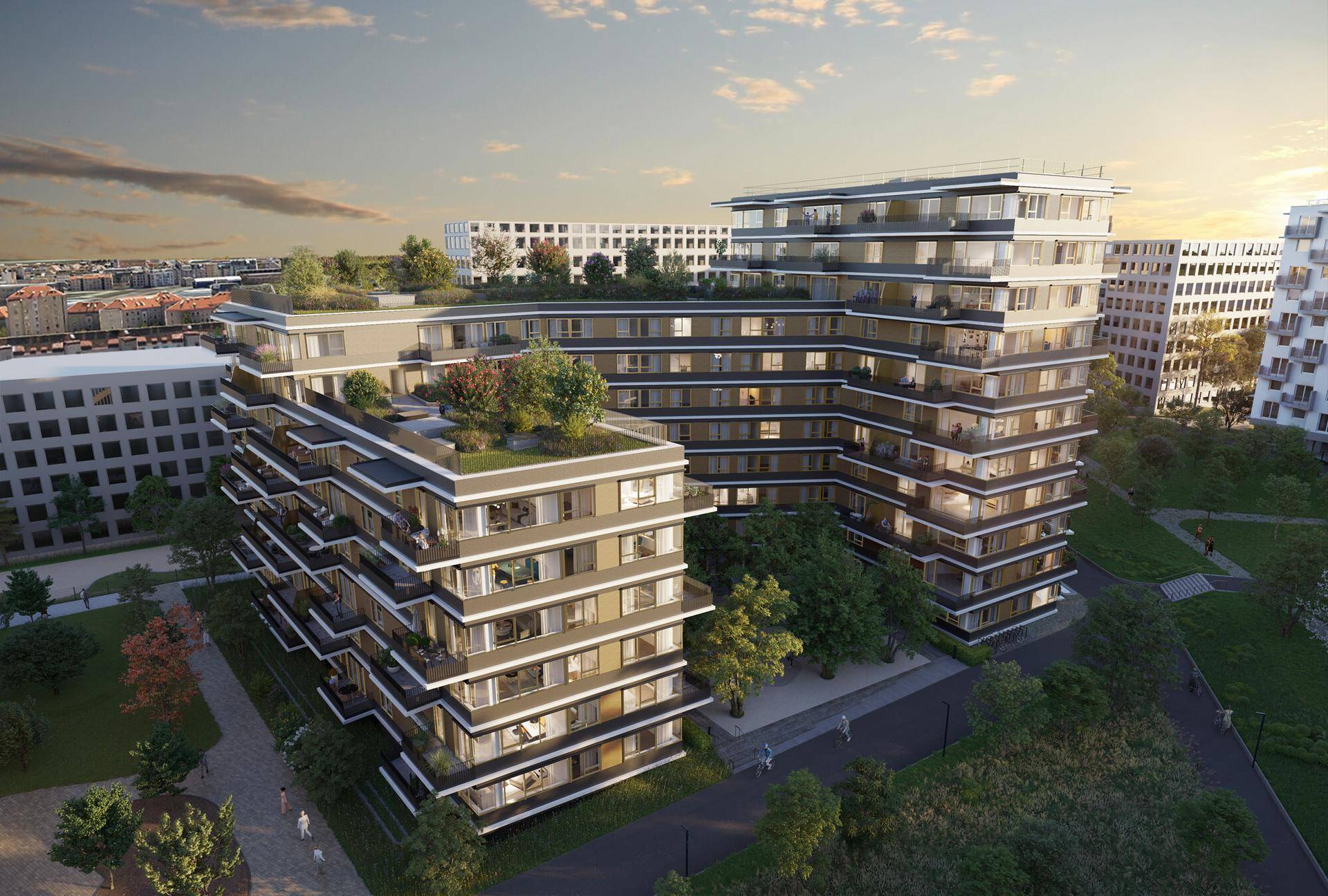 Luftaufnahme eines modernen Wohnkomplexes mit gestuften Balkonen und begrünten Dächern.