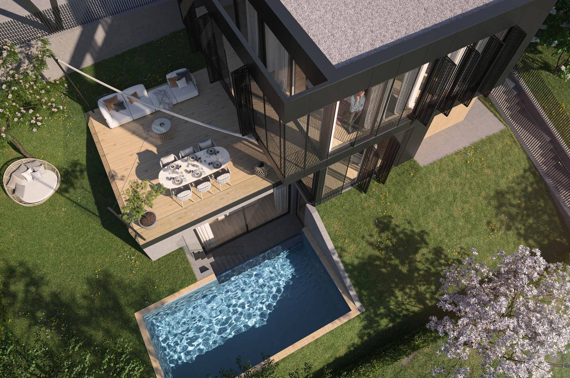 Luftaufnahme einer modernen Villa mit großer Holzterrasse, Essbereich und privatem Pool.