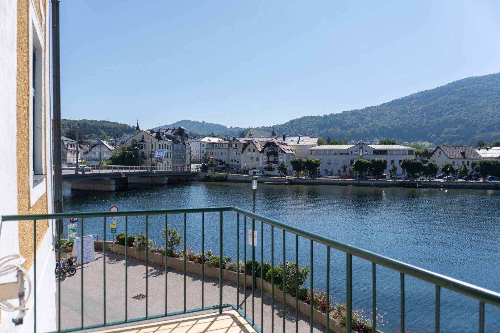Balkon mit Blick auf den Fluss, die Stadt und die umliegenden grünen Hügel.