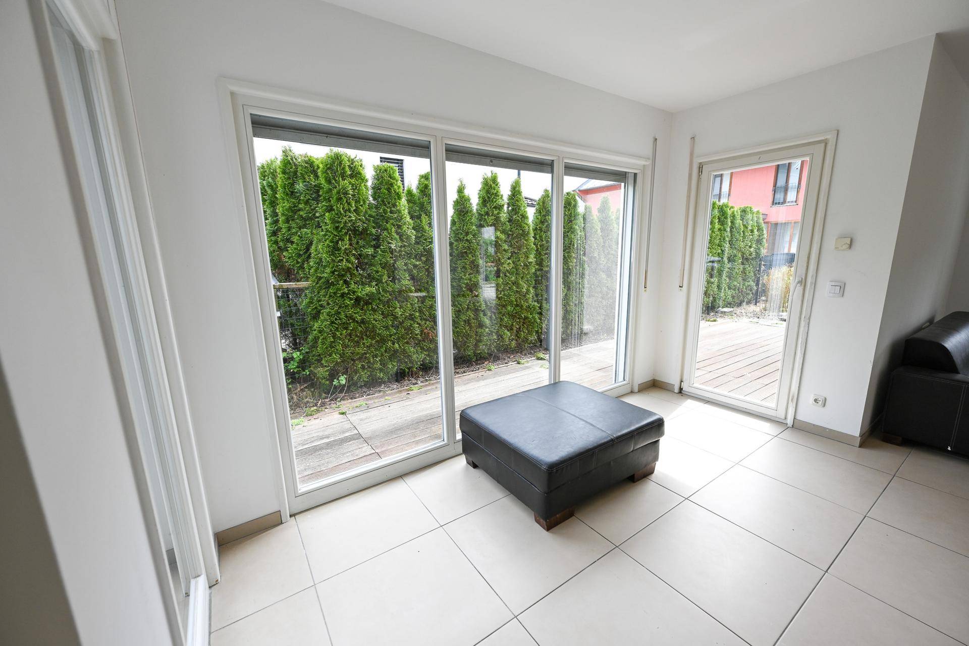 Heller Wohnbereich mit großen Schiebetüren und direktem Zugang zur Terrasse.
