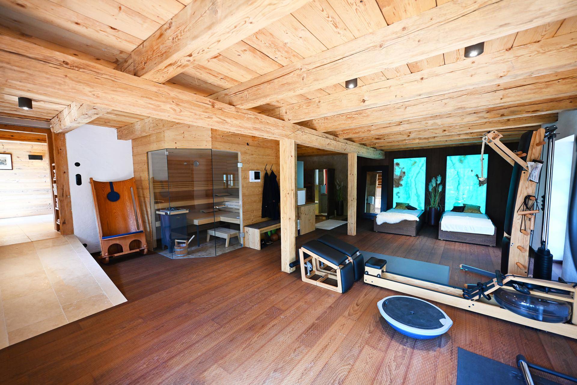 Großzügiger Wellnessbereich mit Sauna und Fitnessgeräten, ideal für Entspannung und Training.